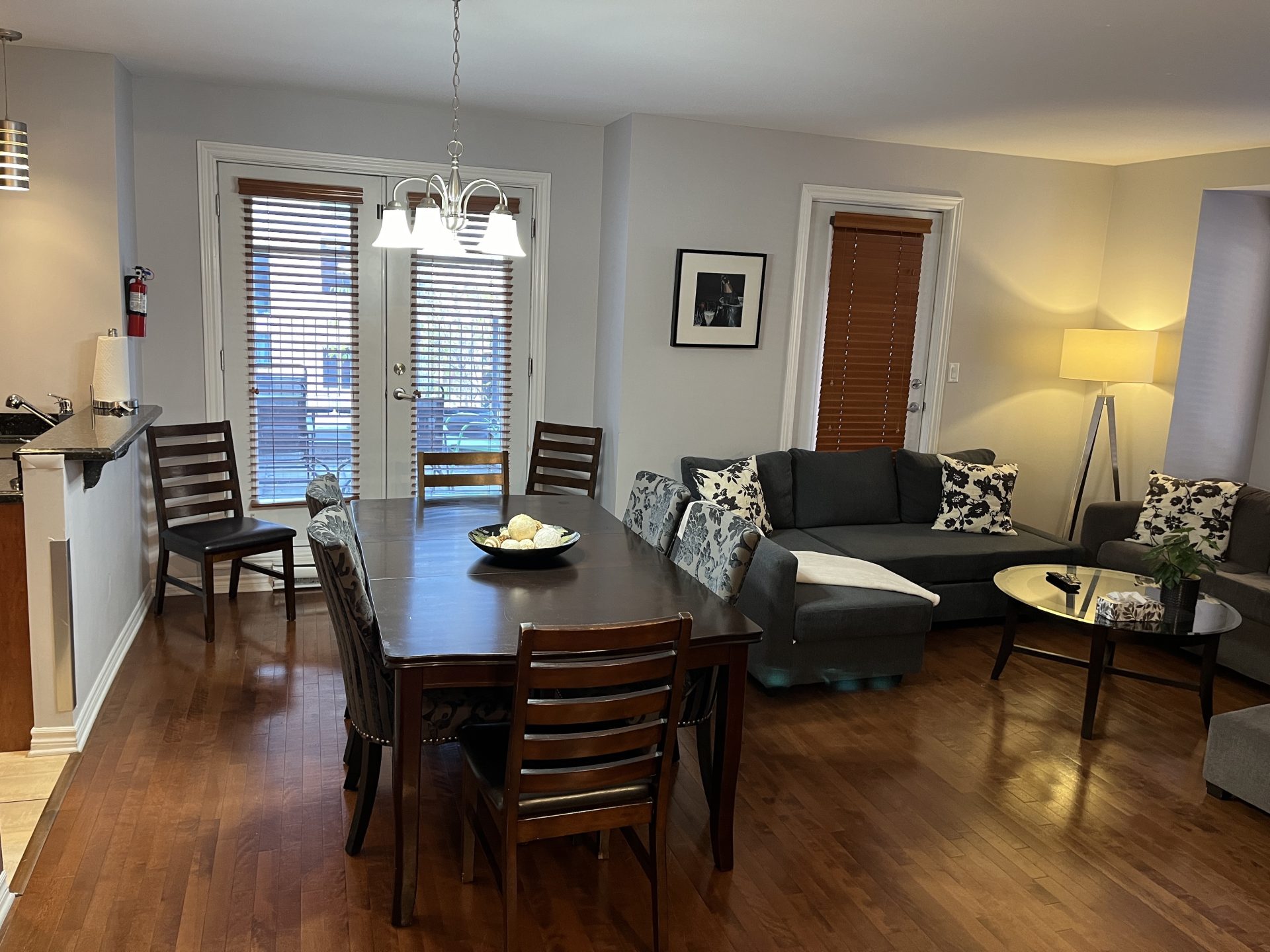 Open-concept dining space with a dark wood table and chairs