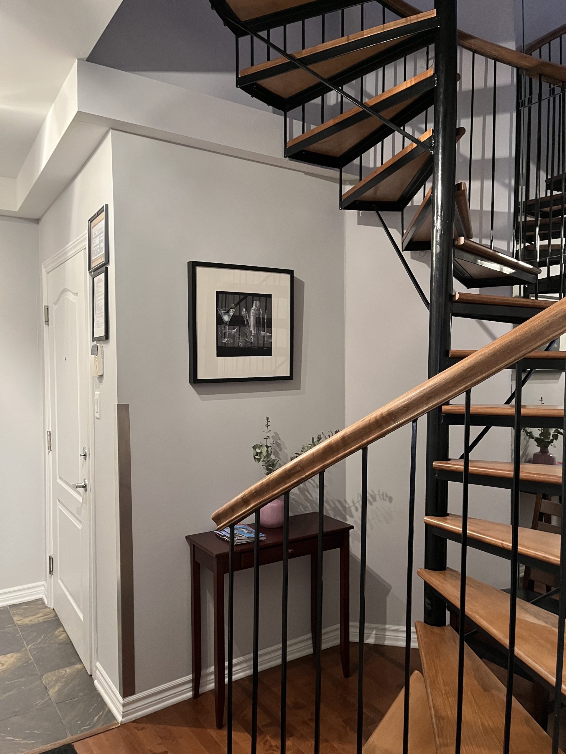 Spiral wooden staircase leading to a second floor.