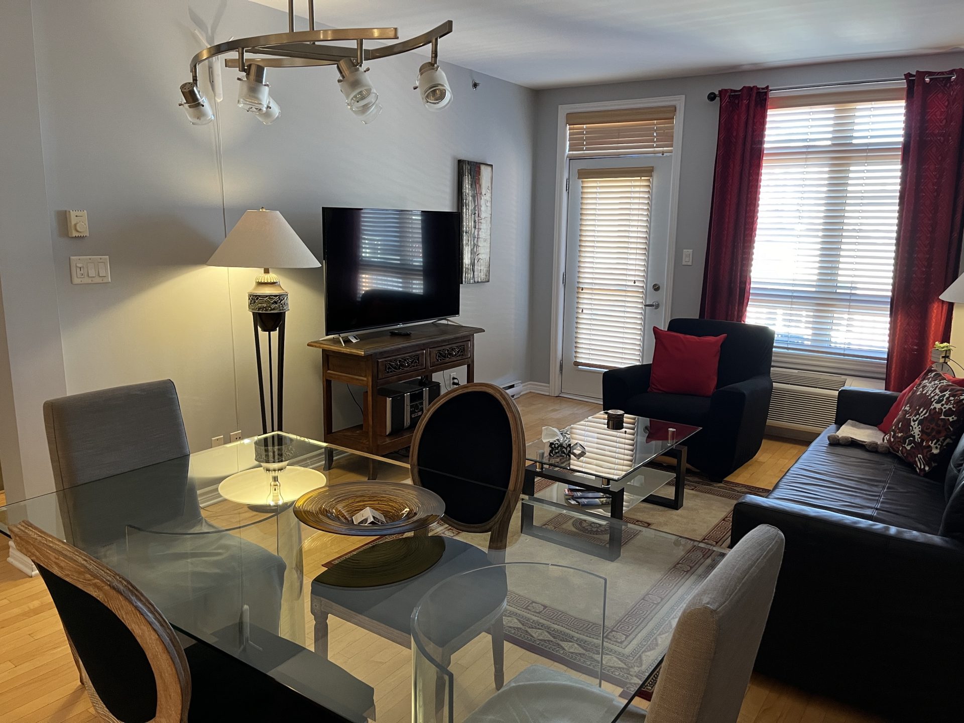 Open-concept dining space with a dark wood table and chairs.